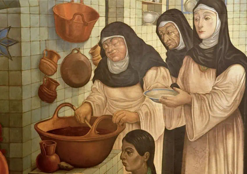 A painting of nuns in beige cloaks and black and white habits work in a Mexican kitchen to point out the connection between Mexican fudge and Mexico's nuns.