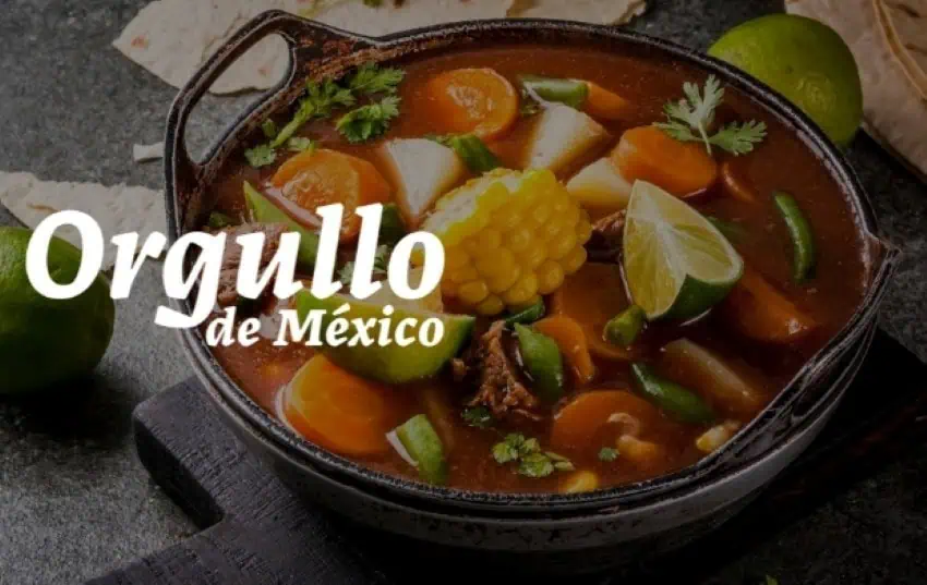 An image of a serving of Mexico's classic dish mole de olla — a vegetable and beef soup or stew — seen here in a traditional cast iron serving dish