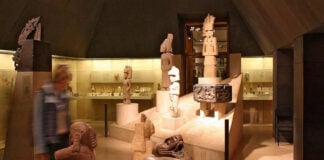 A museum room filled with sculptures and artifacts on display, all made by ancient Mexican indigenous cultures.