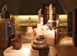 A museum room filled with sculptures and artifacts on display, all made by ancient Mexican indigenous cultures.