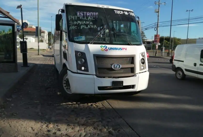 Puerto Vallarta public bus turning out to leave a stop on a city street.