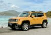 A yellow Jeep on a beach