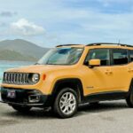 A yellow Jeep on a beach