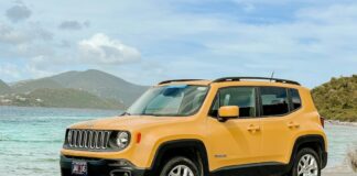 A yellow Jeep on a beach