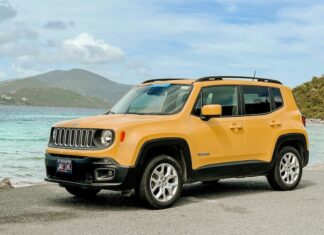 A yellow Jeep on a beach