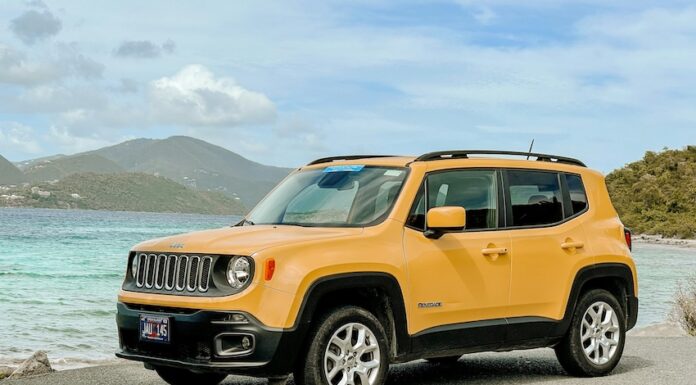 A yellow Jeep on a beach