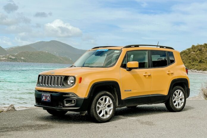 A yellow Jeep on a beach