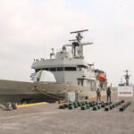 Mexican navy ship at dock with seized bricks of cocaine.