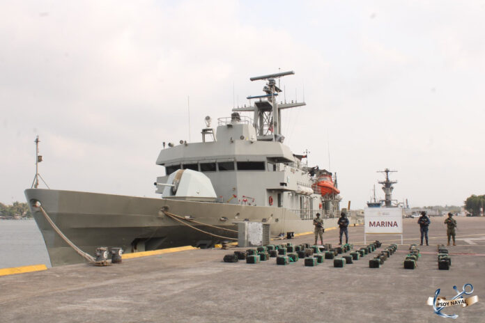 Mexican navy ship at dock with seized bricks of cocaine.