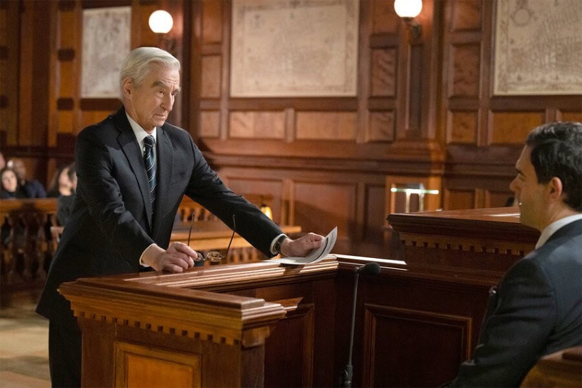 A still from the NBC series Law and Order showing the show's character, Prosecutor Jack Mc Coy, questioning a person in court in the witness box.