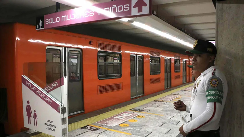 Transit agents guard the metro cars designated for women and children in Mexico City