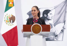 Sheinbaum stands at a podium during her morning press conference or mañanera