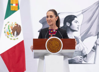 Sheinbaum stands at a podium during her morning press conference or mañanera