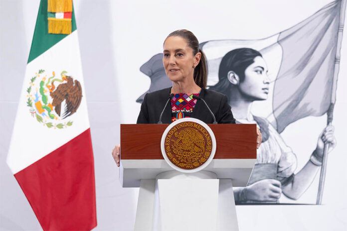 Sheinbaum stands at a podium during her morning press conference or mañanera