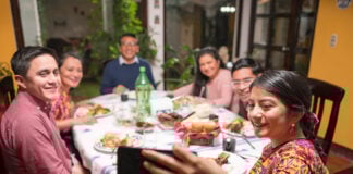 A Mexican family eats food together and enjoys a meal