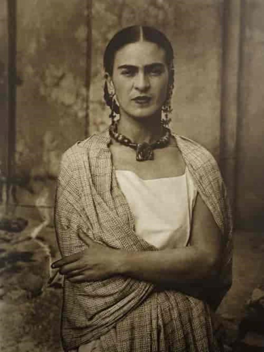 Sepia-toned portrait of Frida Kahlo.