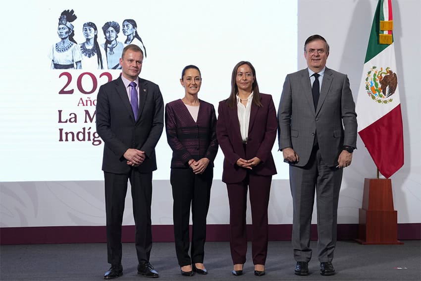 Sheinbaum, Ebrard and two businesspeople stand on a stage