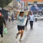 a woman gets caught in the rain in Oaxaca