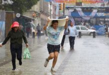 a woman gets caught in the rain in Oaxaca
