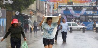 a woman gets caught in the rain in Oaxaca