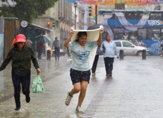 a woman gets caught in the rain in Oaxaca