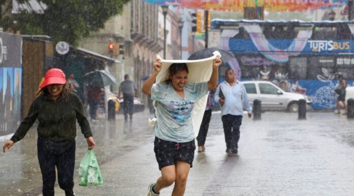 a woman gets caught in the rain in Oaxaca