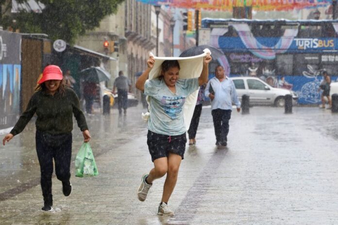 a woman gets caught in the rain in Oaxaca