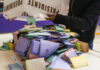 A person dumps a box of votes onto a table