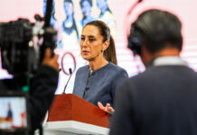 A camera films Sheinbaum as she speaks at her morning press conference