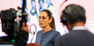 A camera films Sheinbaum as she speaks at her morning press conference