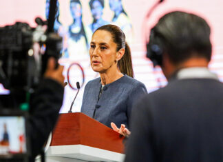 A camera films Sheinbaum as she speaks at her morning press conference