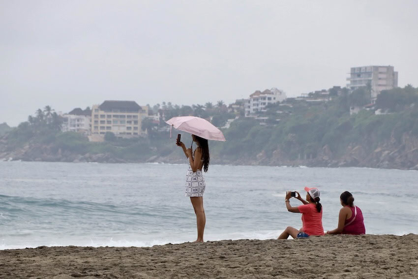 3 people on a beach