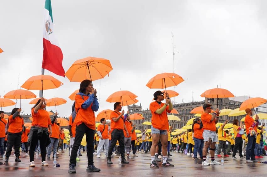 People participate in a giant pride flag in Mexico City's Zócalo