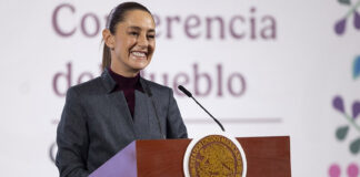 President Sheinbaum stands behind a podium at her morning press conference