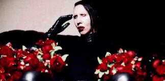 Man with face makeup holding flowers