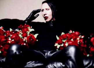 Man with face makeup holding flowers