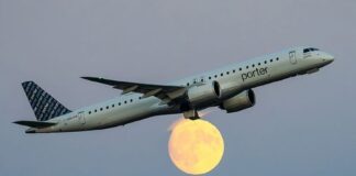 jet flying in front of moon