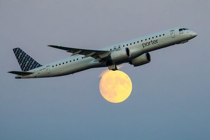 jet flying in front of moon