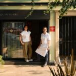 Two people in front of a restaurant