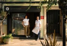 Two people in front of a restaurant