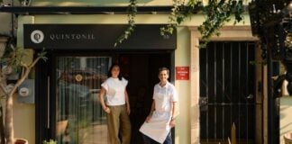 Two people in front of a restaurant
