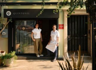 Two people in front of a restaurant
