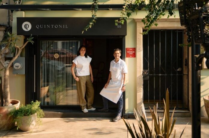 Two people in front of a restaurant