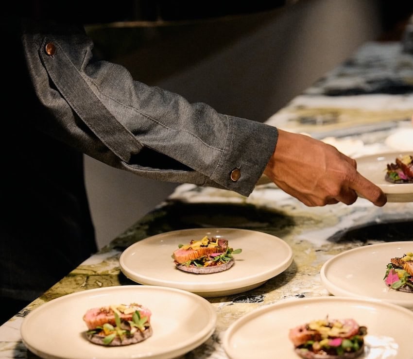 arm and hand preparing restaurant dishes