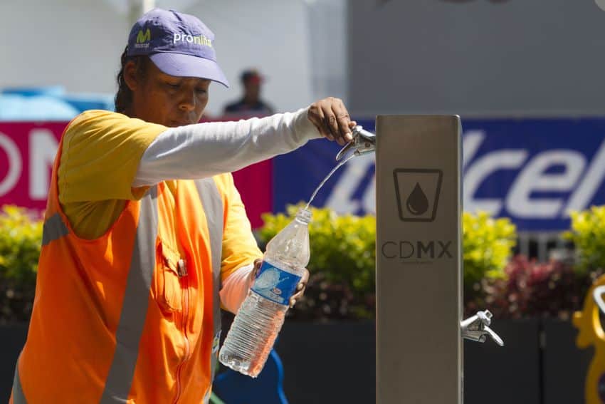 man filling bottle with water