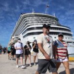 Tourists walking near cruise ship