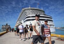 Tourists walking near cruise ship
