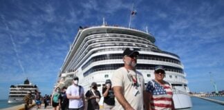Tourists walking near cruise ship