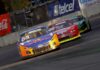 A nascar car races down a track