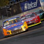 A nascar car races down a track